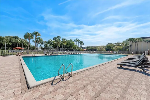 a view of a lake with a yard and a large tree