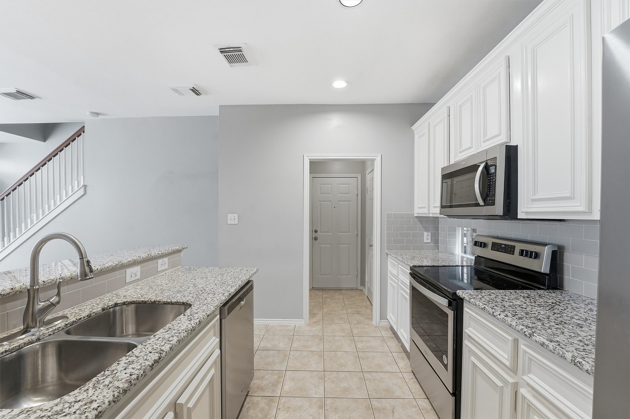 1507 Sutton Street Houston, TX 77006 - Photo 8 of 31 a kitchen with stainless steel appliances granite countertop a sink stove and refrigerator
