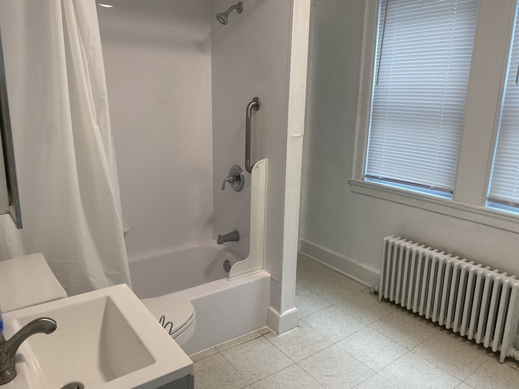 19 Meacham Street, Unit 1 Somerville, MA 02145 - Photo 6 of 11 a bathroom with a bathtub and a sink