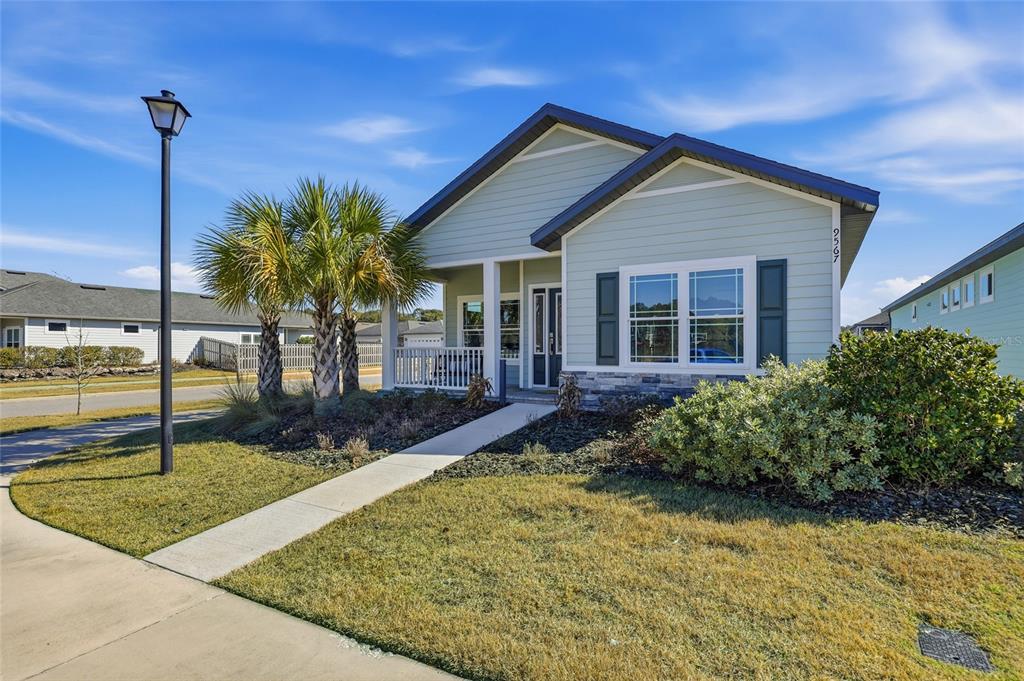 9567 Southwest 66th Lane Gainesville, FL 32608 - Photo 1 of 20 a front view of a house with garden