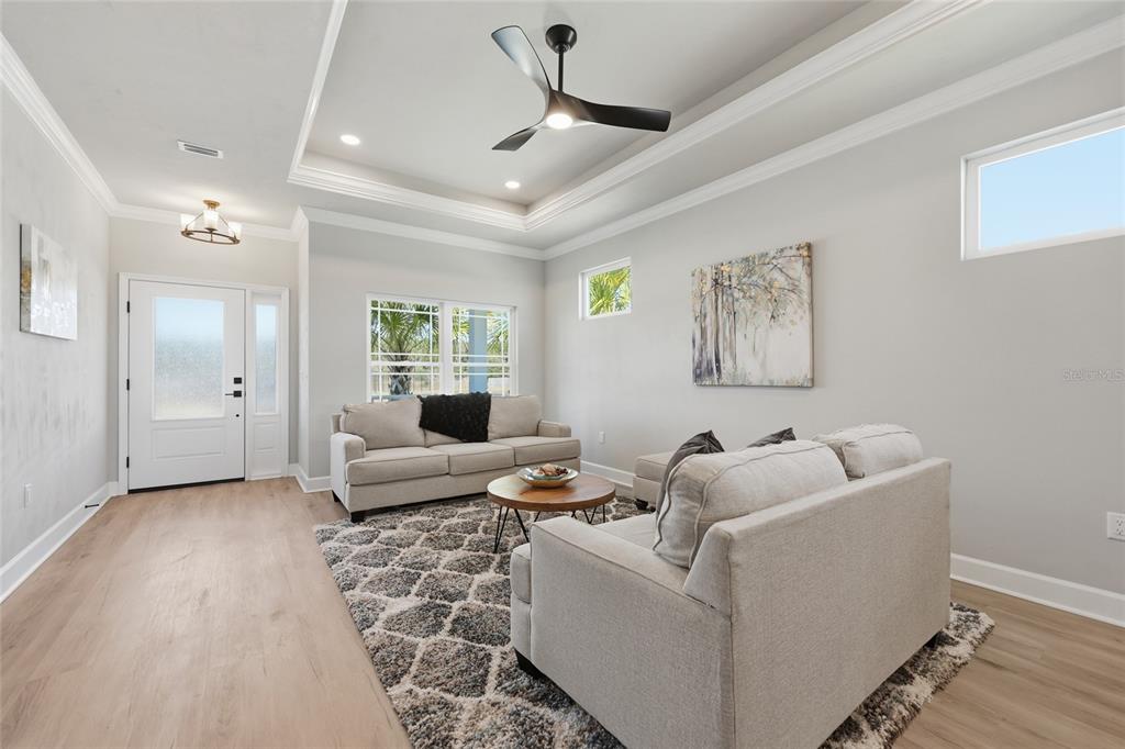 9567 Southwest 66th Lane Gainesville, FL 32608 - Photo 12 of 20 a living room with furniture and a chandelier