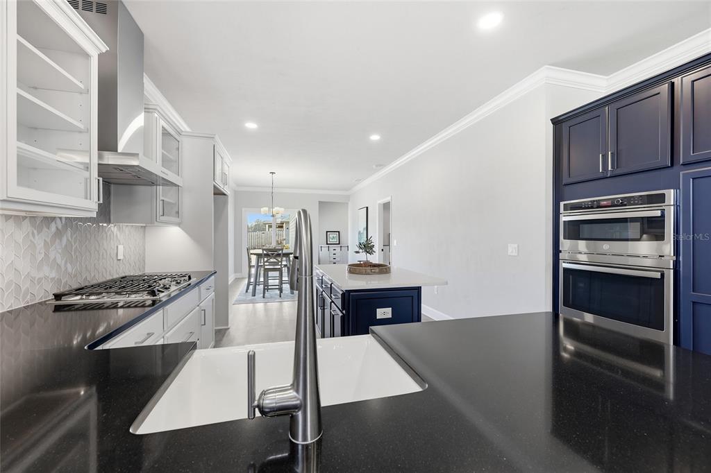 9567 Southwest 66th Lane Gainesville, FL 32608 - Photo 13 of 20 a kitchen with stainless steel appliances granite countertop a stove and a refrigerator
