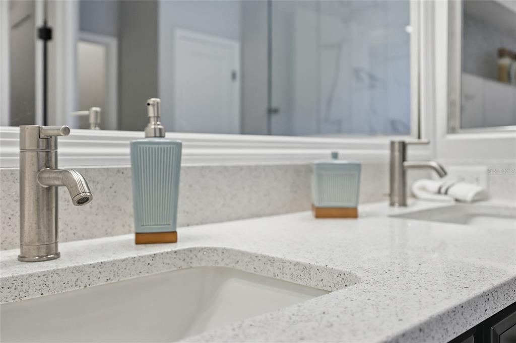 9567 Southwest 66th Lane Gainesville, FL 32608 - Photo 18 of 20 a bathroom with a granite countertop sink and a mirror