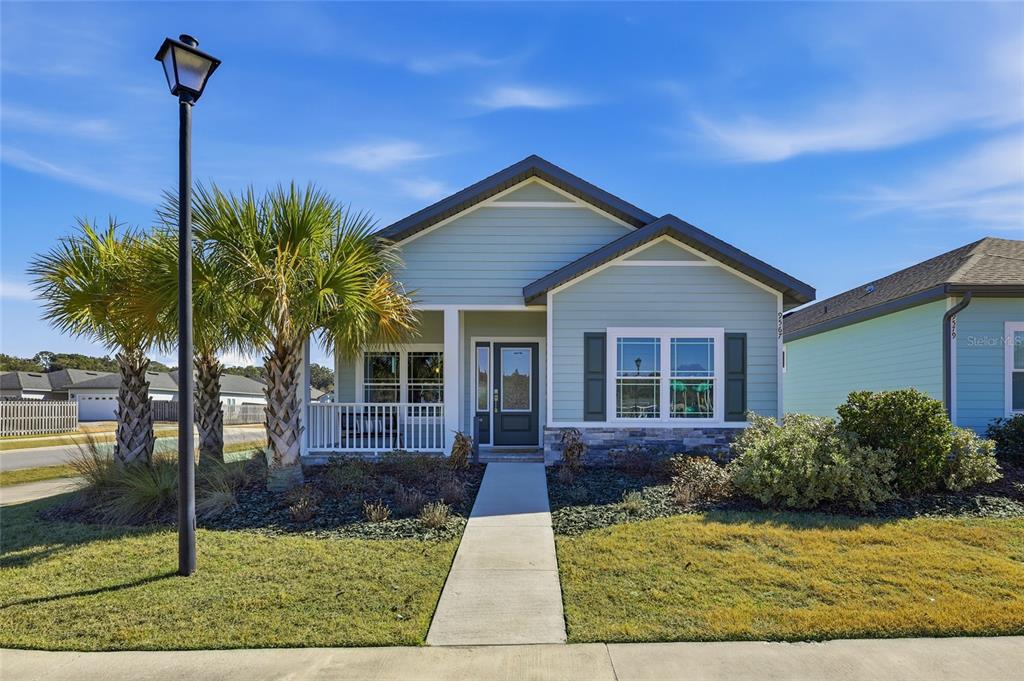 9567 Southwest 66th Lane Gainesville, FL 32608 - Photo 2 of 20 a front view of a house with garden