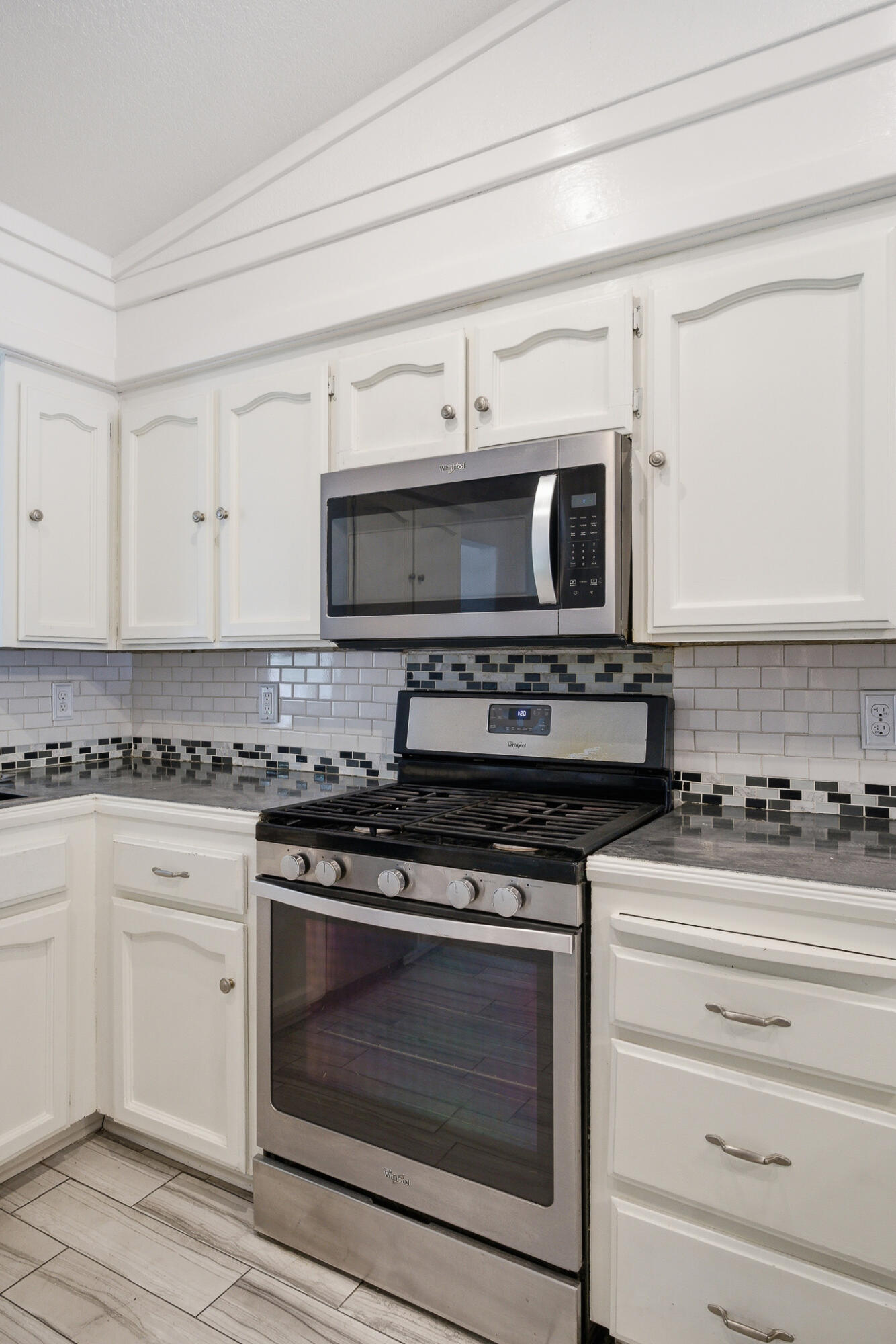618 Birdsong Court Exeter, CA 93221 - Photo 11 of 62 a kitchen with stainless steel appliances granite countertop a stove microwave and cabinets