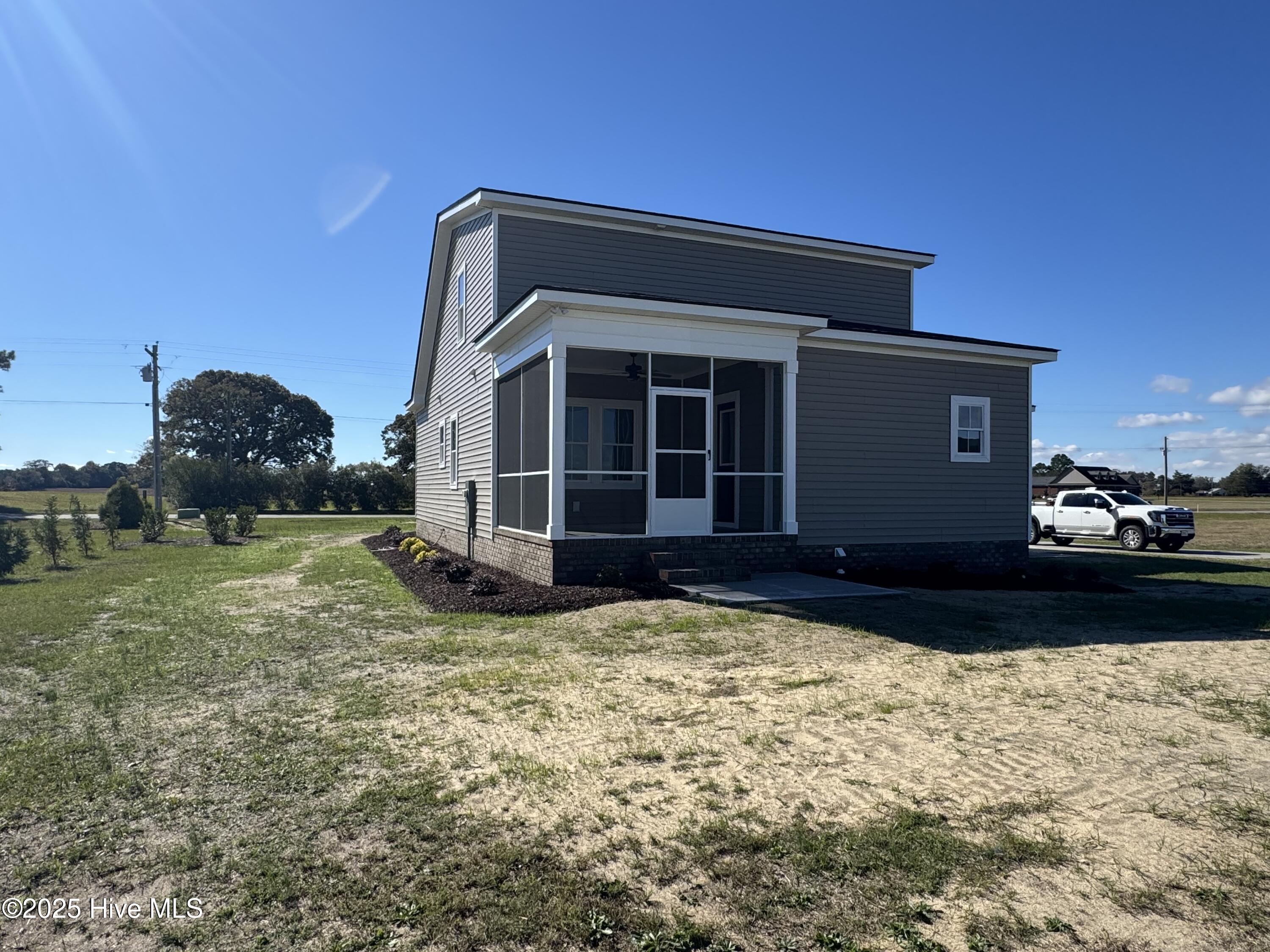 147 Conover Road La Grange, NC 28551 - Photo 2 of 34 Rear screened porch plus small patio