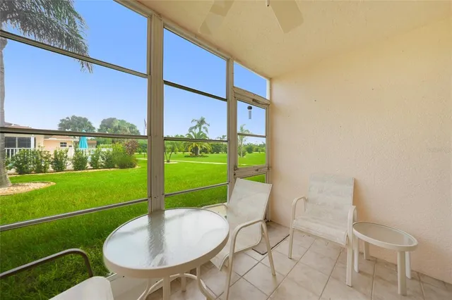 a balcony with a table and chairs