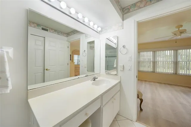a bathroom with a tub a sink and a large mirror