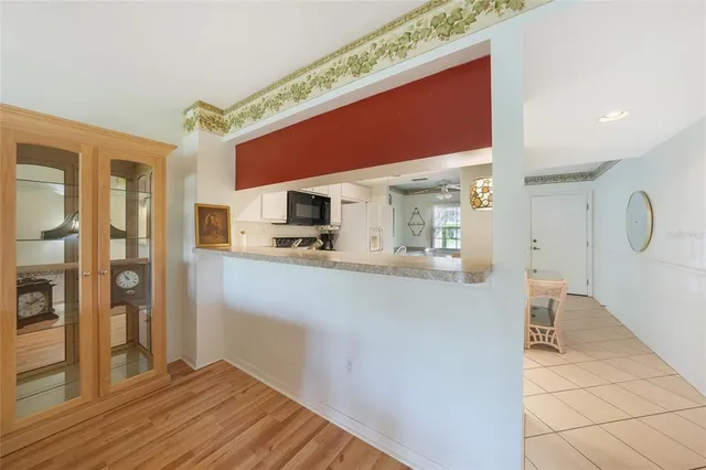 a open kitchen with stainless steel appliances a refrigerator and microwave