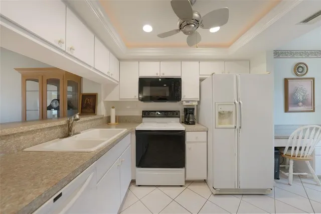 a kitchen with stainless steel appliances granite countertop a stove a refrigerator and a sink
