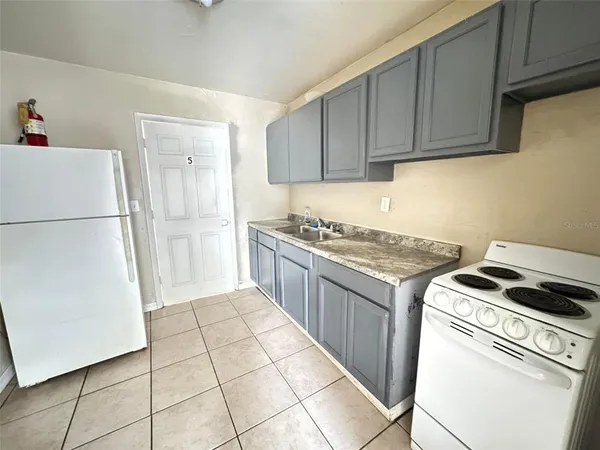 a kitchen with a stove top oven and cabinets