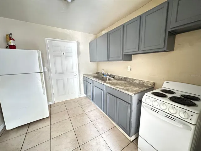 a kitchen with a stove top oven and cabinets