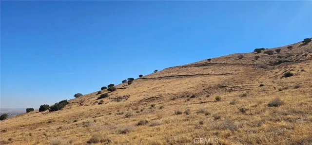 a view of a large building with mountains in the background