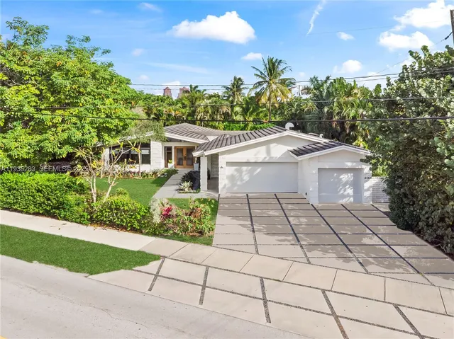 a aerial view of a house with a yard and potted plants