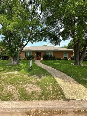 a view of a house with a yard porch and sitting area
