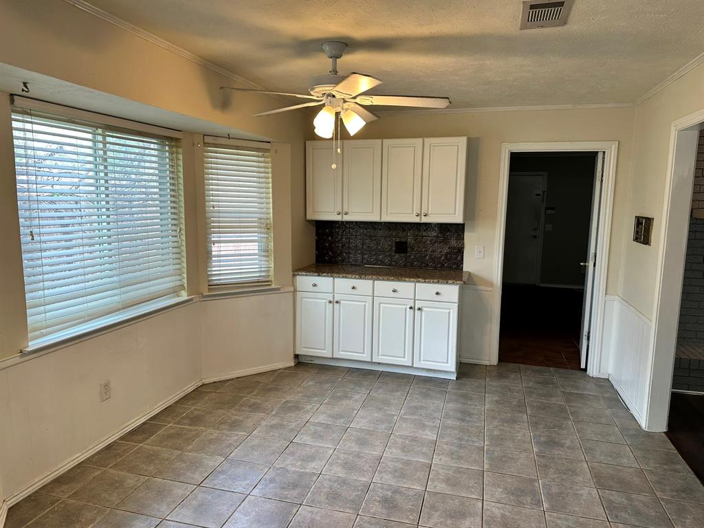 502 Spring Willow Drive Allen, TX 75002 - Photo 12 of 28 a kitchen with a stove a sink and a refrigerator