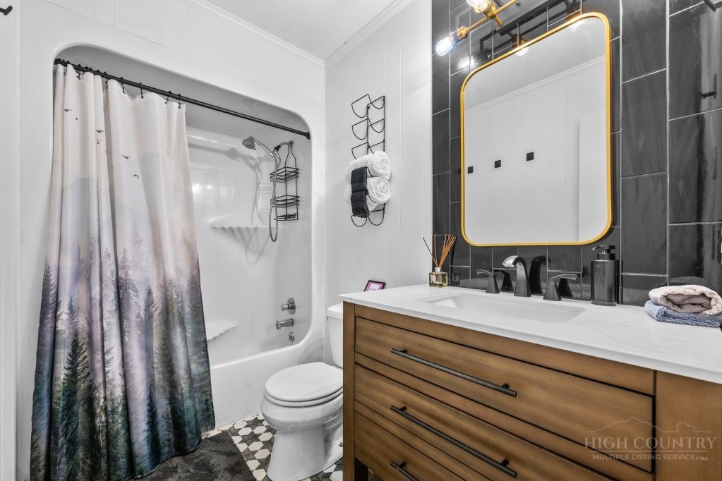 216 Saddle Lane Deep Gap, NC 28618 - Photo 15 of 44 a bathroom with a sink a toilet and shower