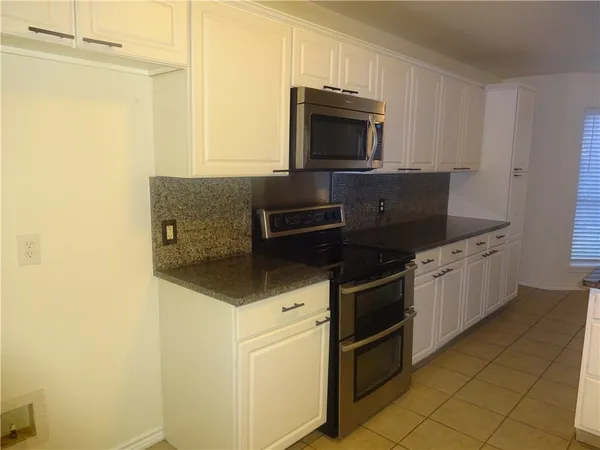 a kitchen with a sink and a refrigerator