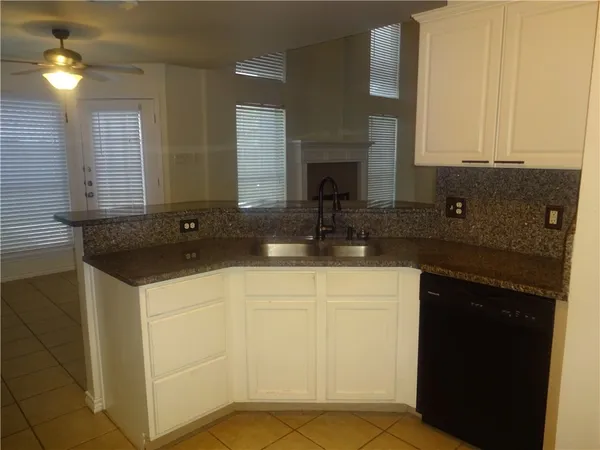 a view of kitchen with stainless steel appliances granite countertop a sink and a stove top oven