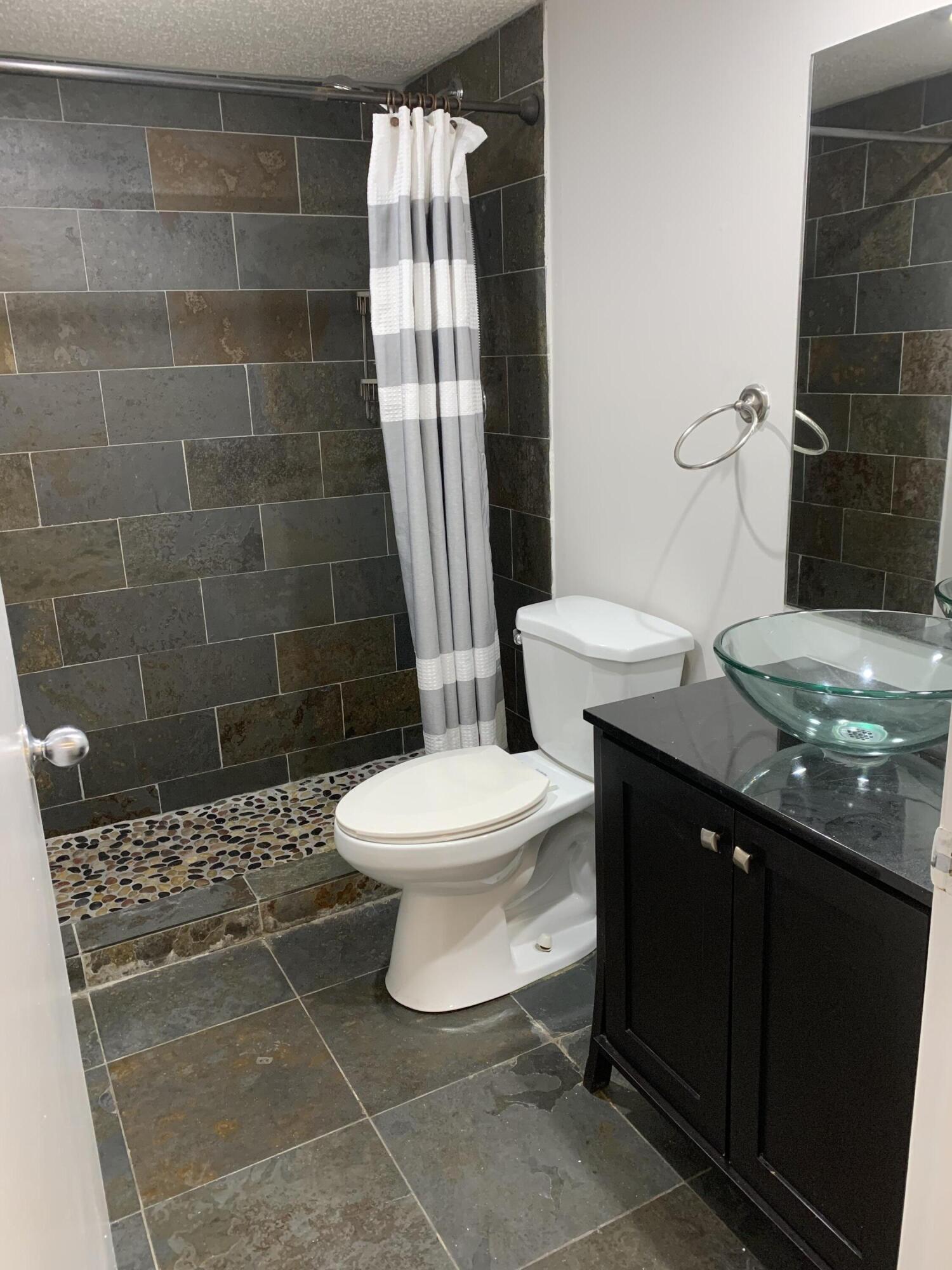 6315 La Costa Drive, Unit E Boca Raton, FL 33433 - Photo 16 of 22 a bathroom with a sink a toilet and shower