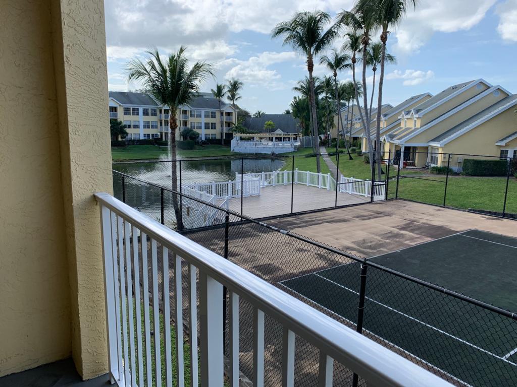6315 La Costa Drive, Unit E Boca Raton, FL 33433 - Photo 20 of 22 a swimming pool with a yard and palm trees