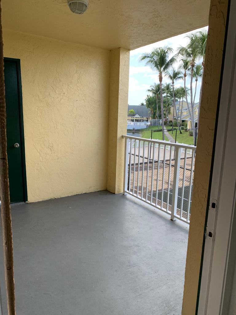 6315 La Costa Drive, Unit E Boca Raton, FL 33433 - Photo 21 of 22 a view of a room with sliding door and wooden floor