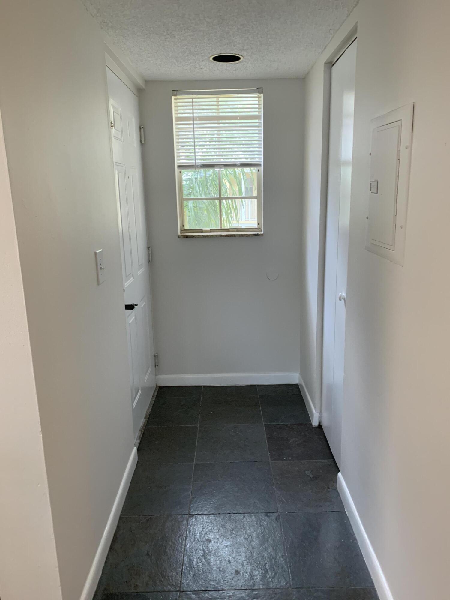 6315 La Costa Drive, Unit E Boca Raton, FL 33433 - Photo 5 of 22 an empty room with a window