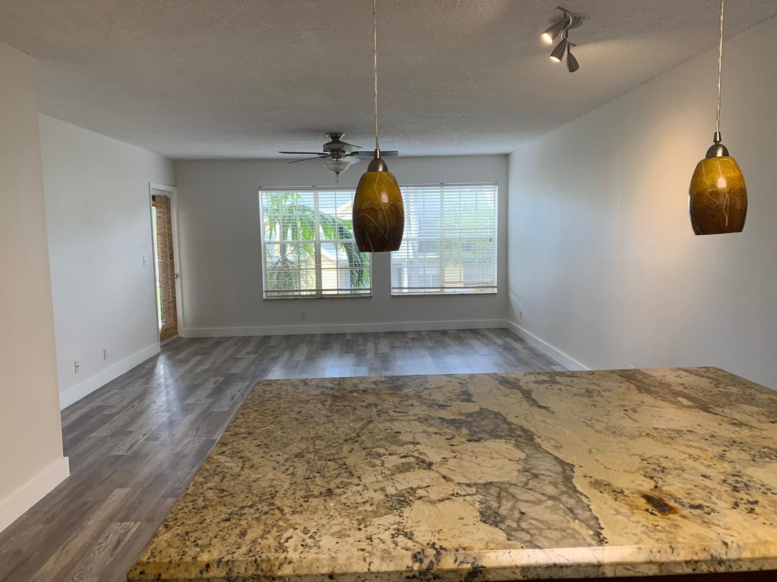 6315 La Costa Drive, Unit E Boca Raton, FL 33433 - Photo 9 of 22 a view of a room with wooden floor and window