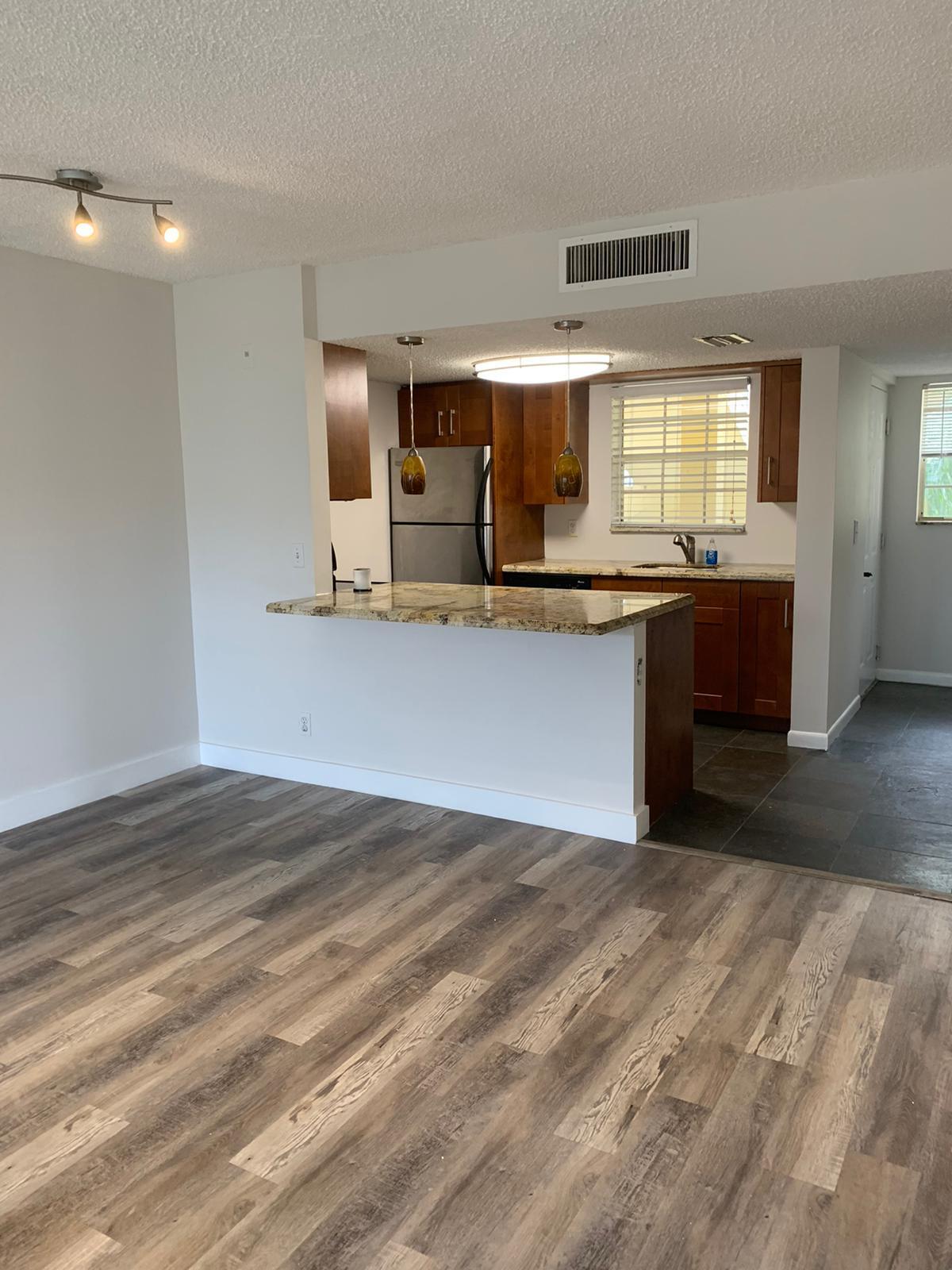 6315 La Costa Drive, Unit E Boca Raton, FL 33433 - Photo 10 of 22 a view of kitchen with sink microwave and cabinets