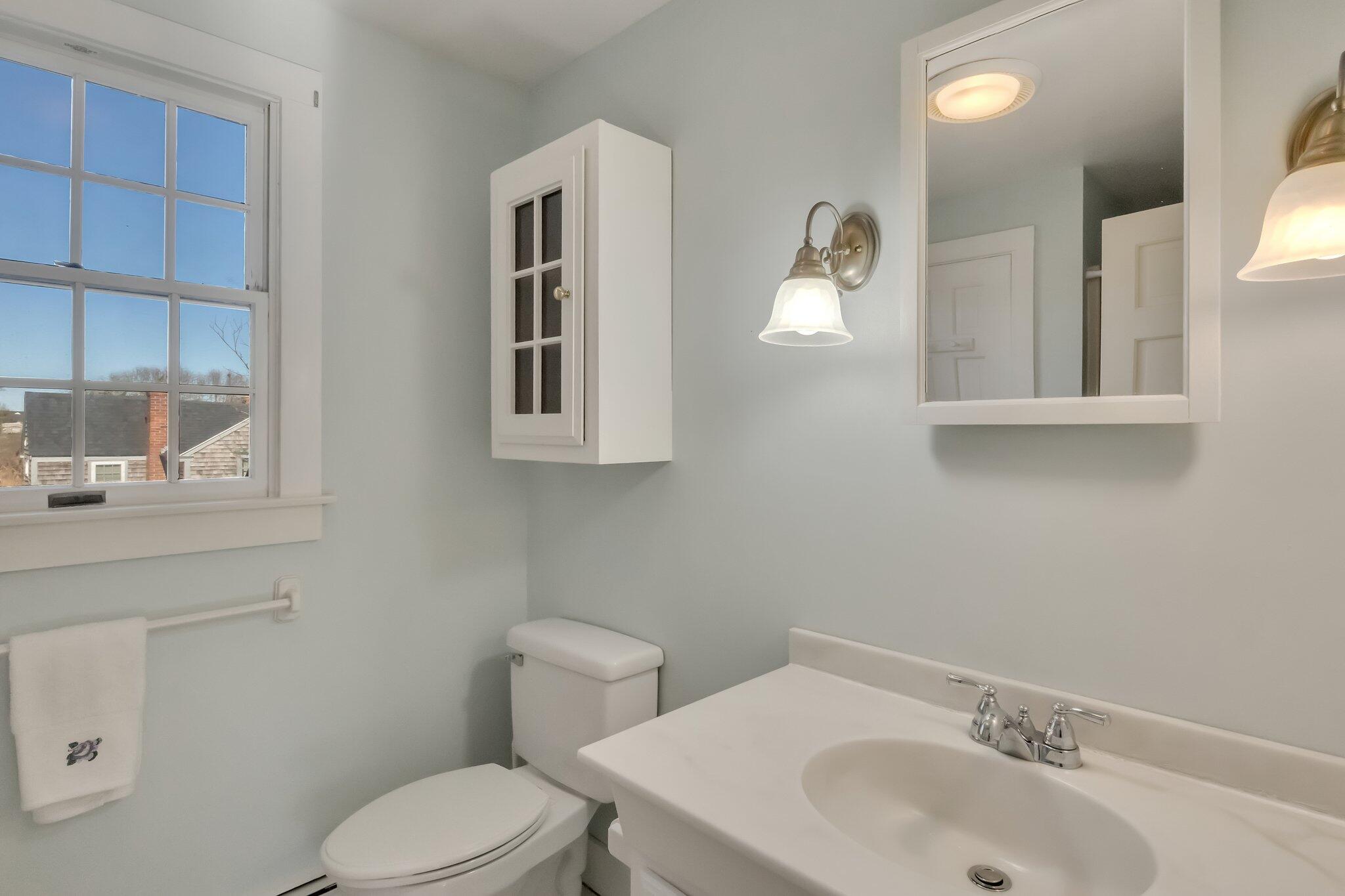 400 Lower County Road Harwich Port, MA 02646 - Photo 25 of 49 a bathroom with a toilet a sink and mirror