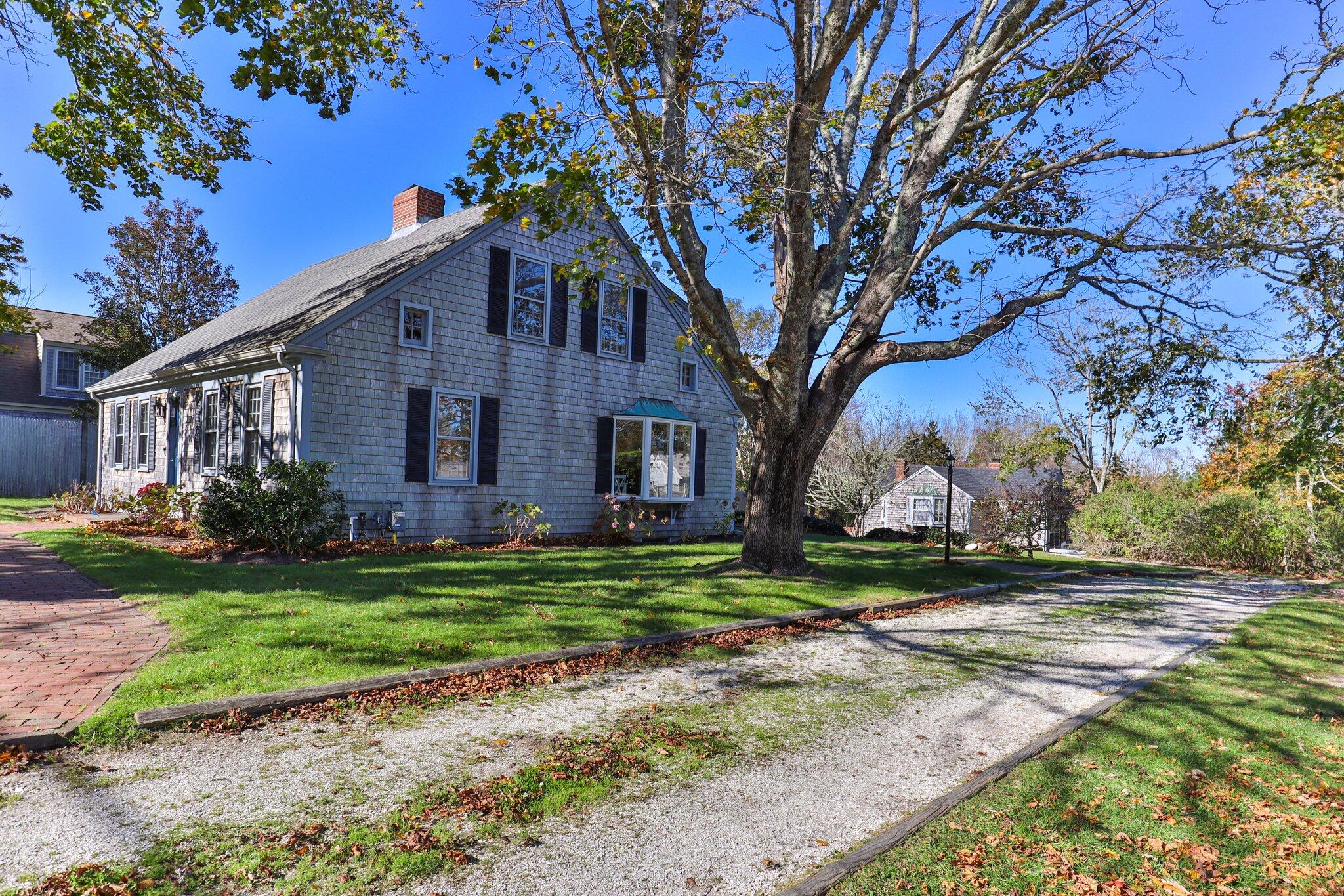 400 Lower County Road Harwich Port, MA 02646 - Photo 3 of 49 a front view of a house with a yard and garage