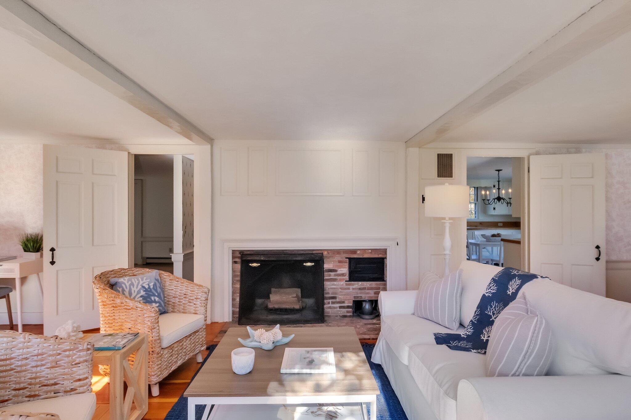 400 Lower County Road Harwich Port, MA 02646 - Photo 8 of 49 a living room with furniture and a fireplace