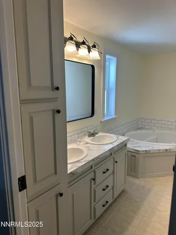 a bathroom with a granite countertop sink and mirror