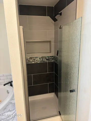 a bathroom with a shower and a sink