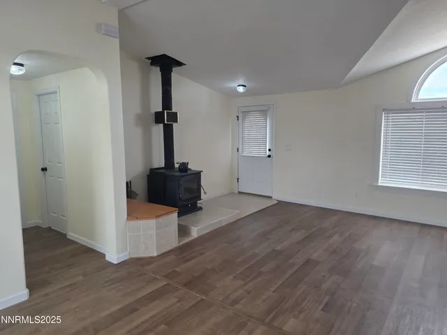 a view of a livingroom with wooden floor and staircase