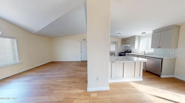 a open kitchen with white cabinets and white appliances