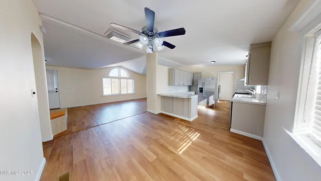 a view of kitchen and hall with wooden floor