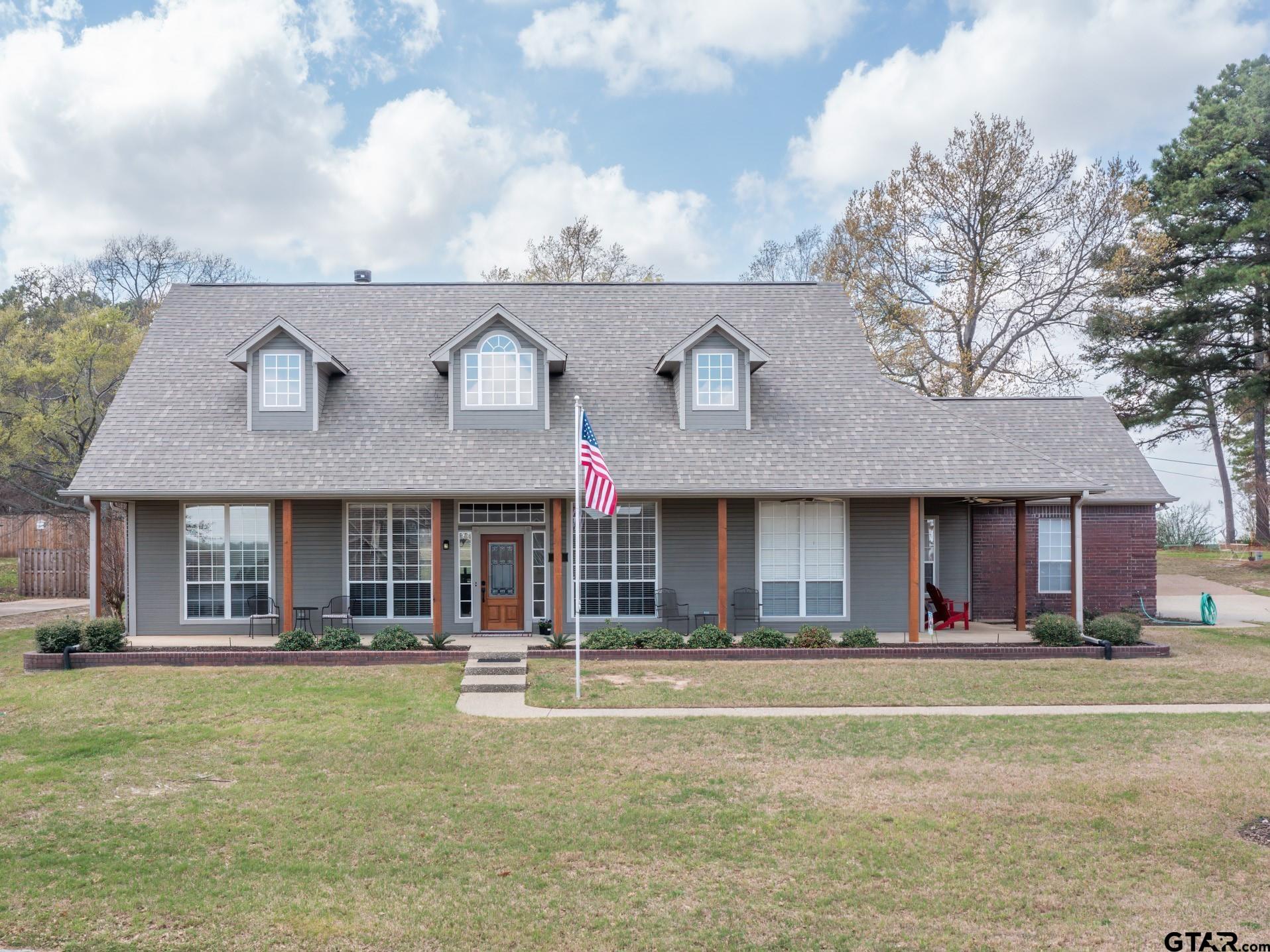 a front view of brick house with a yard
