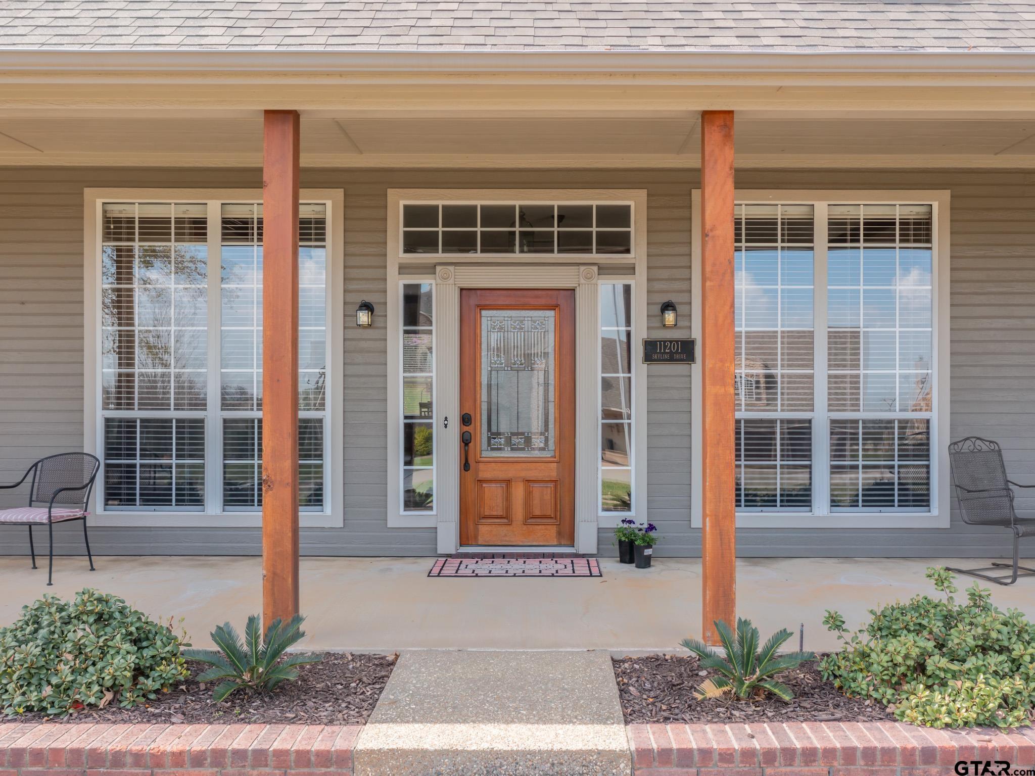 11201 Skyline Drive Brownsboro, TX 75756 - Photo 15 of 39 a front view of a house with a yard and potted plants
