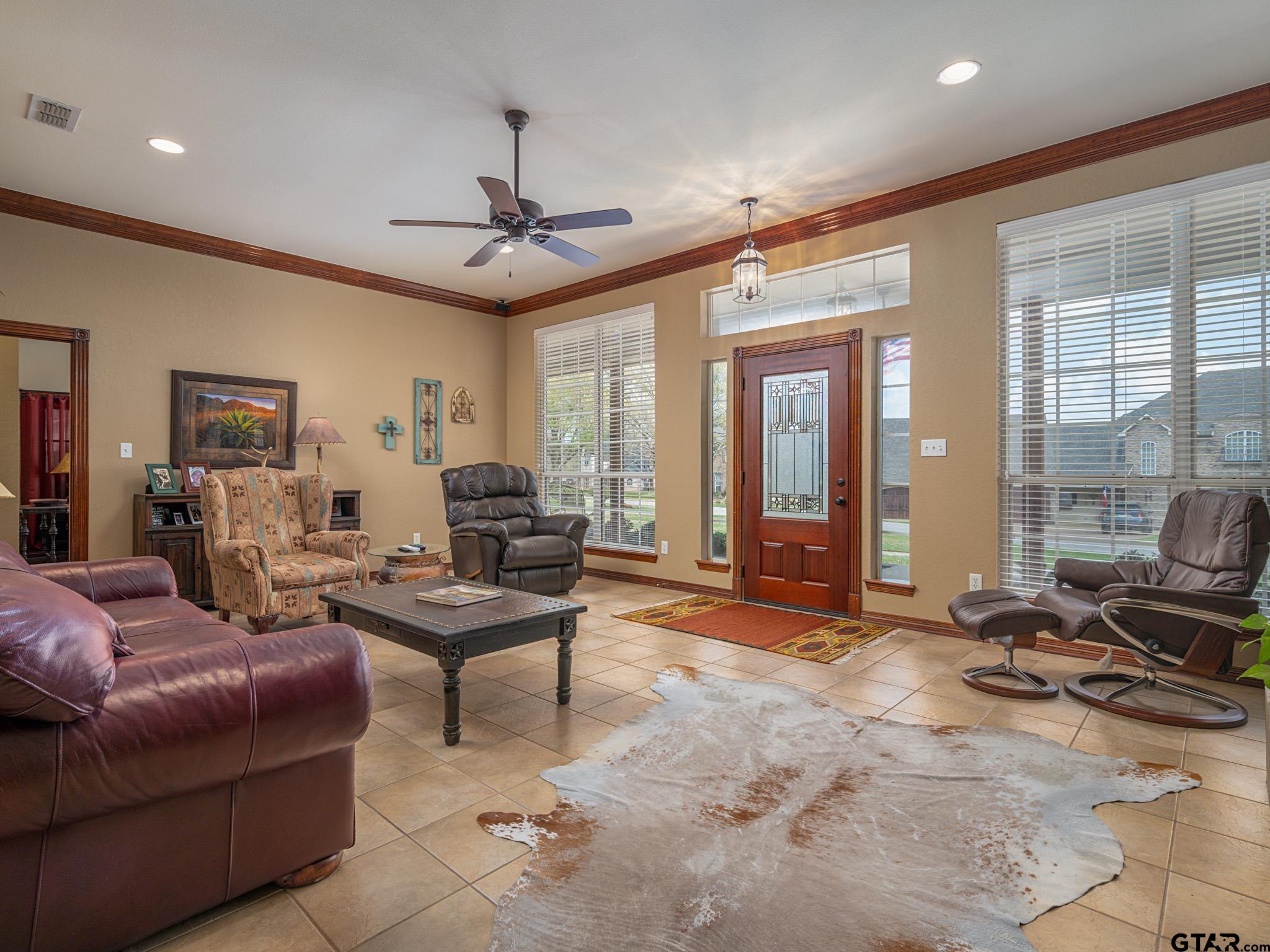 11201 Skyline Drive Brownsboro, TX 75756 - Photo 19 of 39 a living room with furniture a flat screen tv and a large window