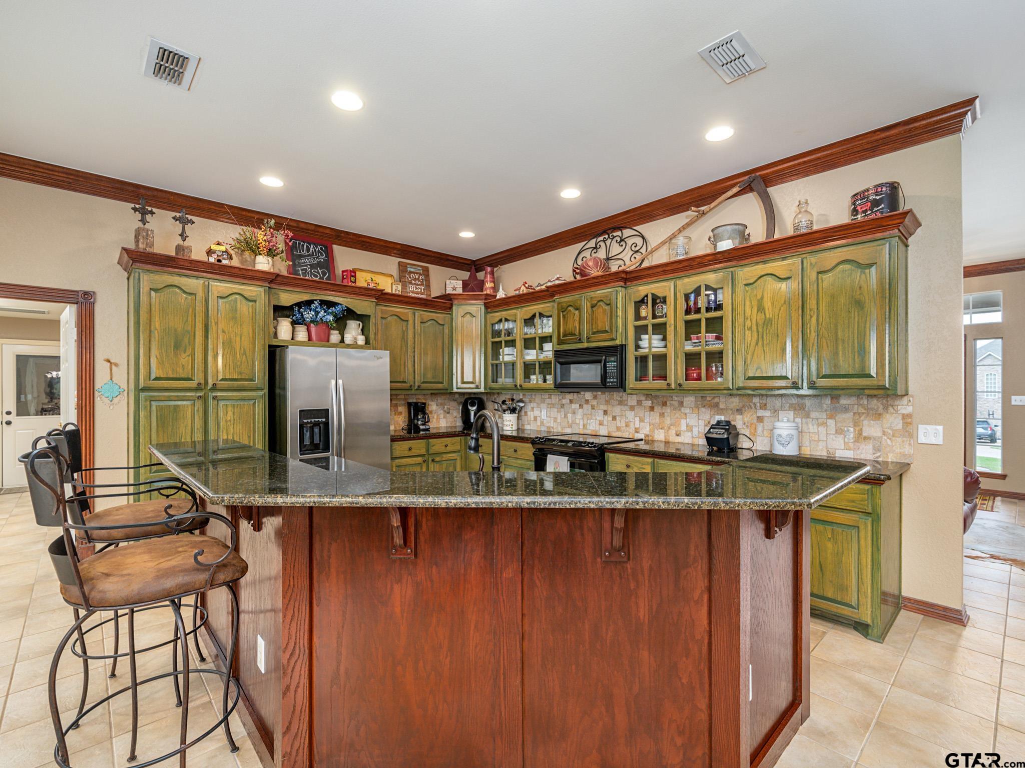 11201 Skyline Drive Brownsboro, TX 75756 - Photo 22 of 39 a kitchen with stainless steel appliances kitchen island granite countertop a sink and cabinets