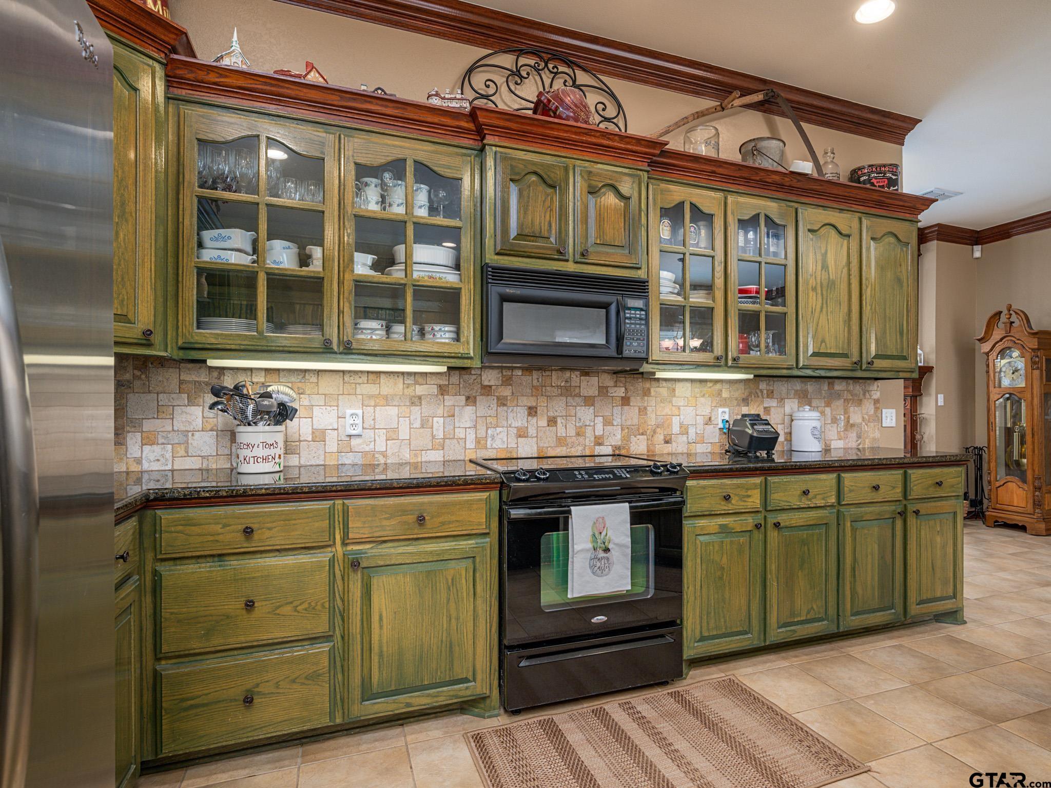 11201 Skyline Drive Brownsboro, TX 75756 - Photo 24 of 39 a kitchen with stainless steel appliances granite countertop a stove and cabinets