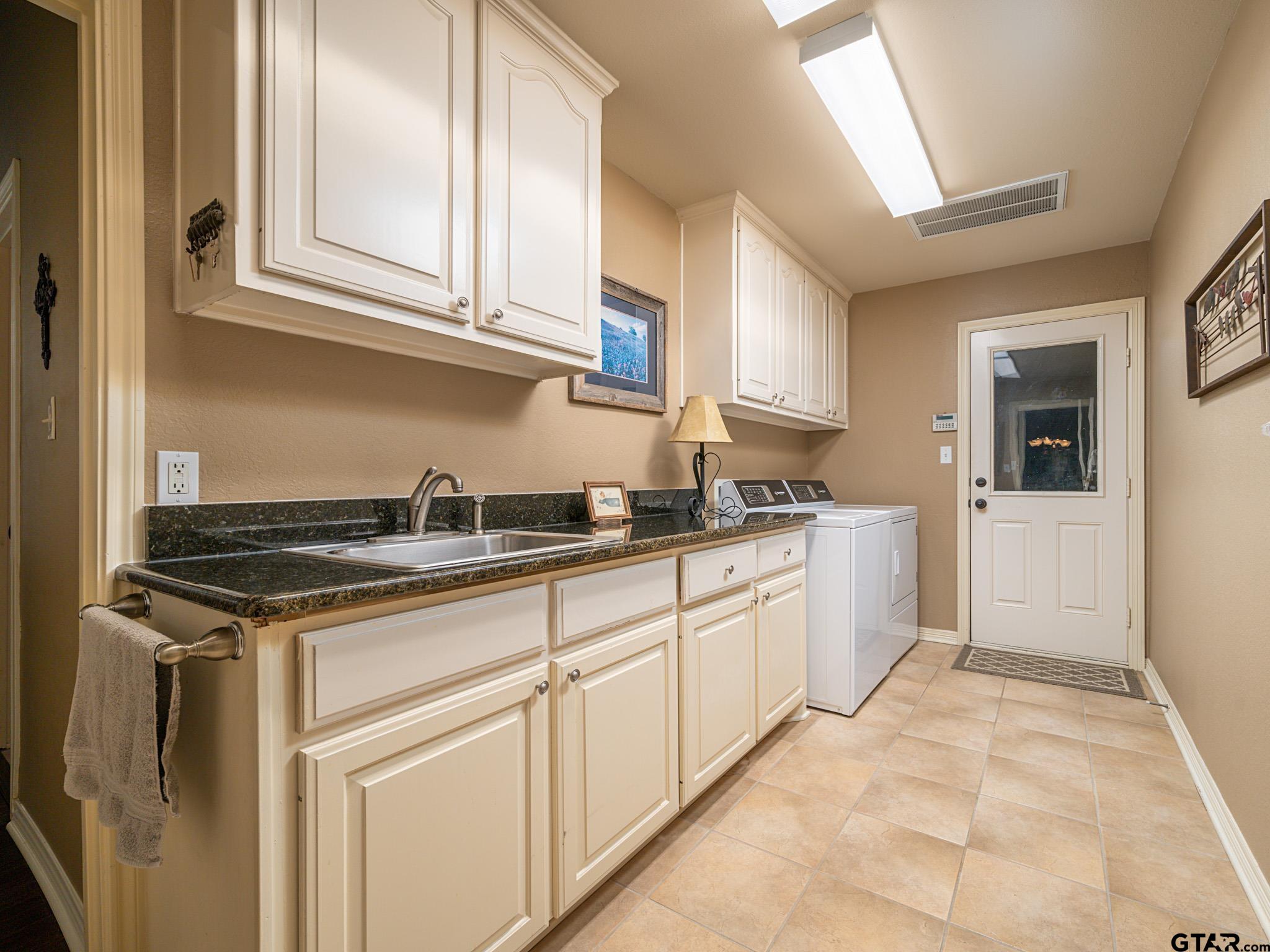 11201 Skyline Drive Brownsboro, TX 75756 - Photo 26 of 39 a kitchen with granite countertop a sink and cabinets