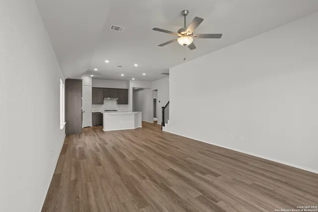 a view of a kitchen with a sink and a refrigerator