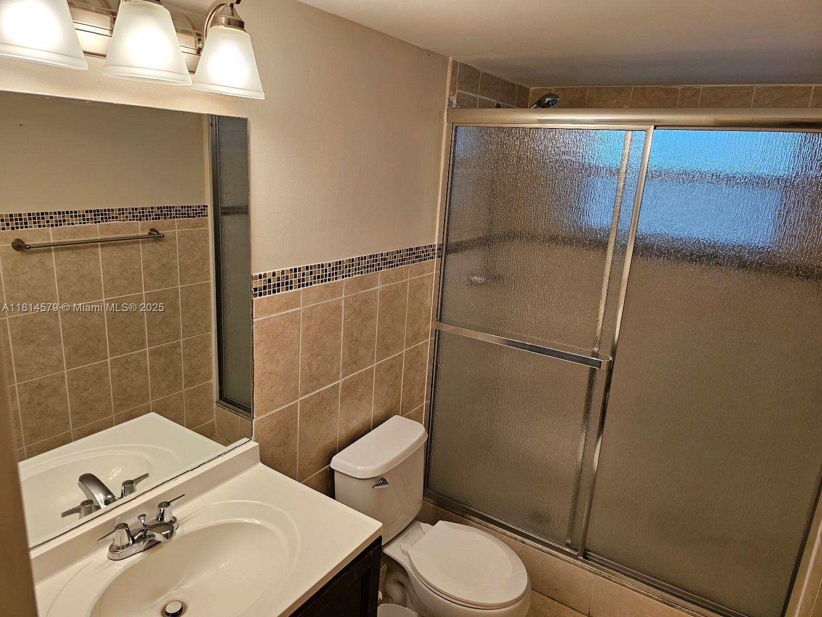 8380 Sands Point Boulevard, Unit J110 Tamarac, FL 33321 - Photo 18 of 34 a bathroom with a sink toilet and shower