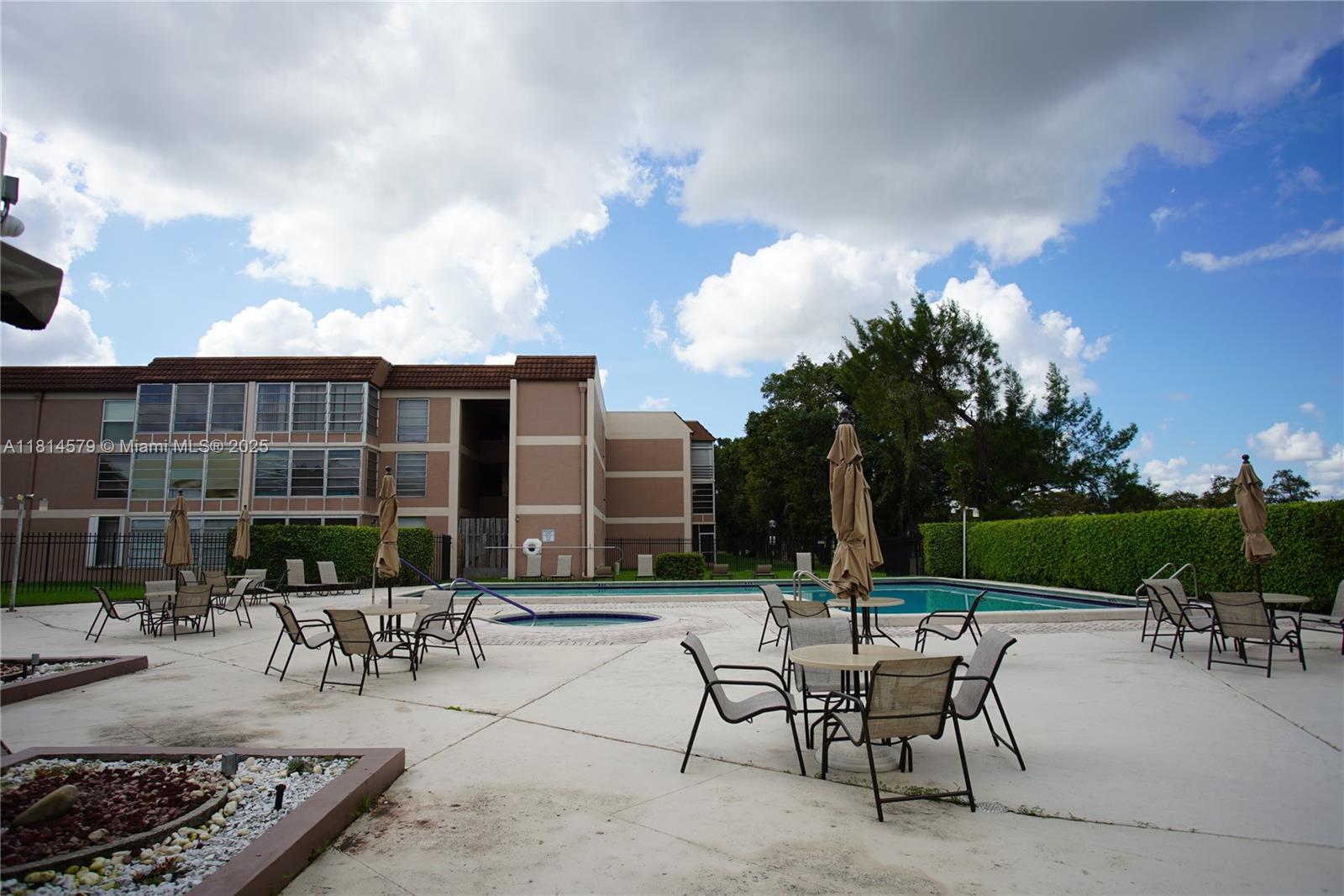 8380 Sands Point Boulevard, Unit J110 Tamarac, FL 33321 - Photo 24 of 34 a view of a patio with a table and chairs