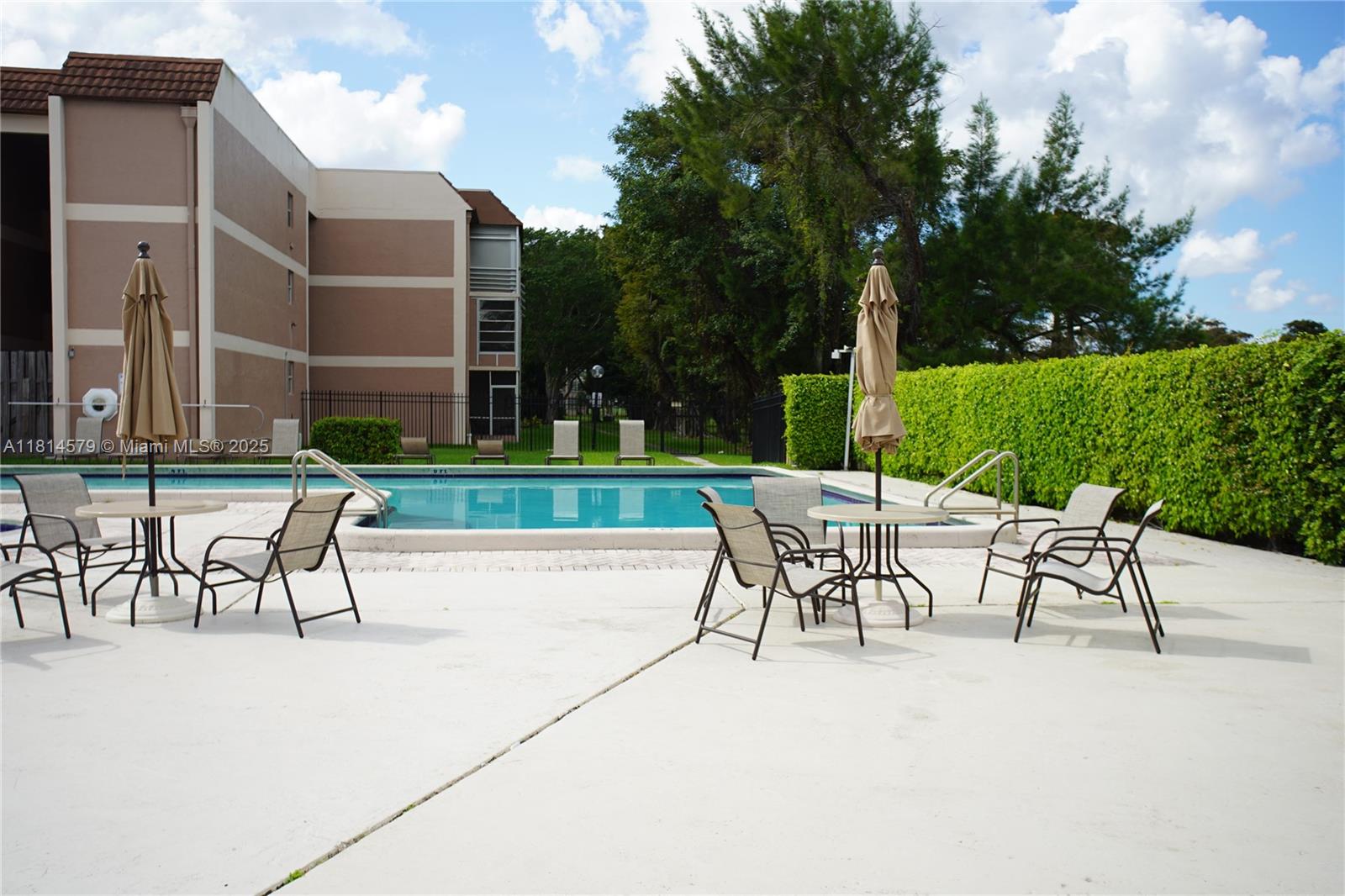 8380 Sands Point Boulevard, Unit J110 Tamarac, FL 33321 - Photo 25 of 34 a view of a patio with a table and chairs