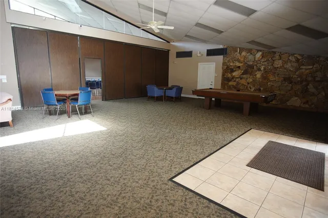 a living room with furniture and large windows