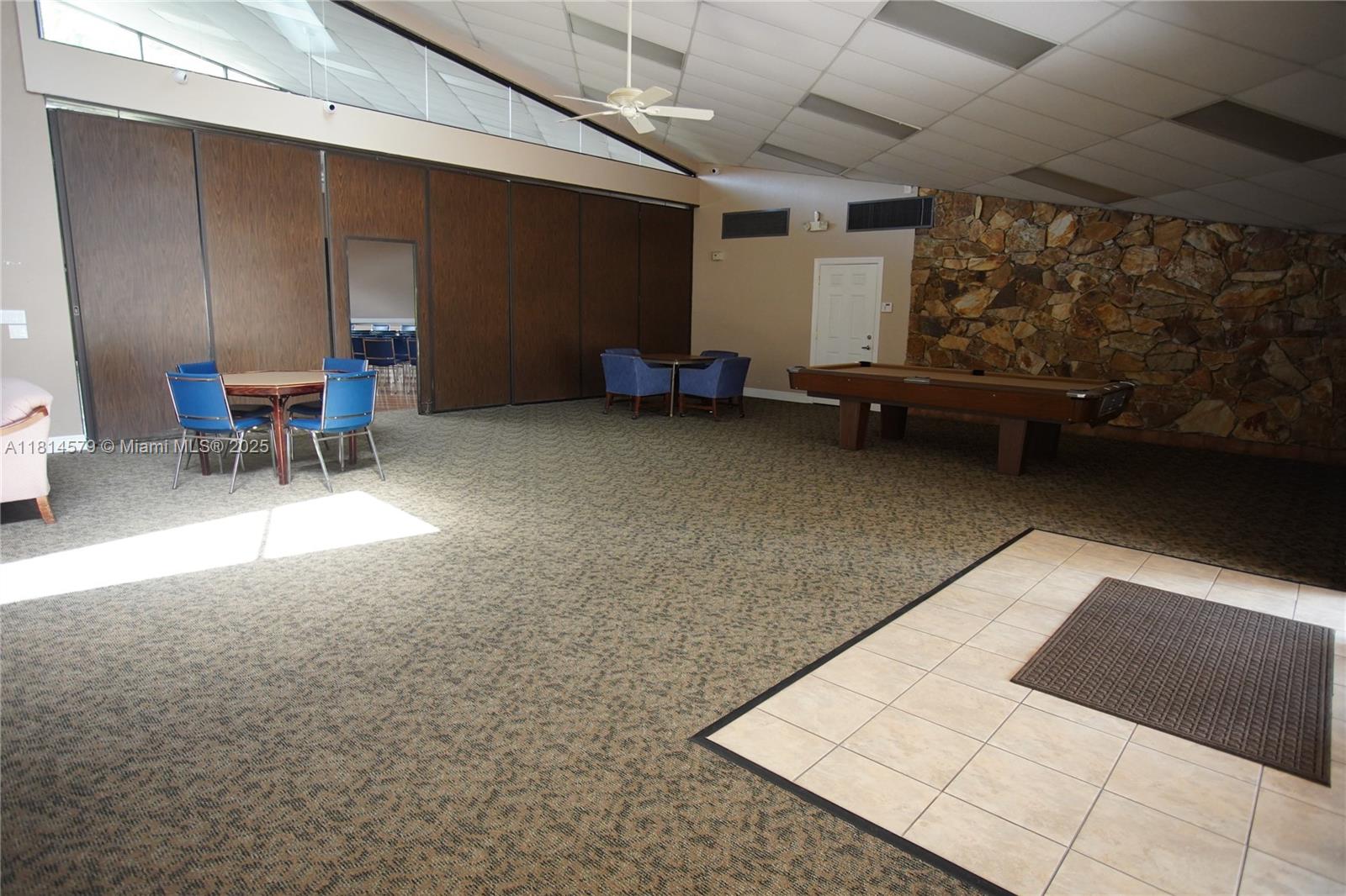 8380 Sands Point Boulevard, Unit J110 Tamarac, FL 33321 - Photo 30 of 34 a living room with furniture and a pool table