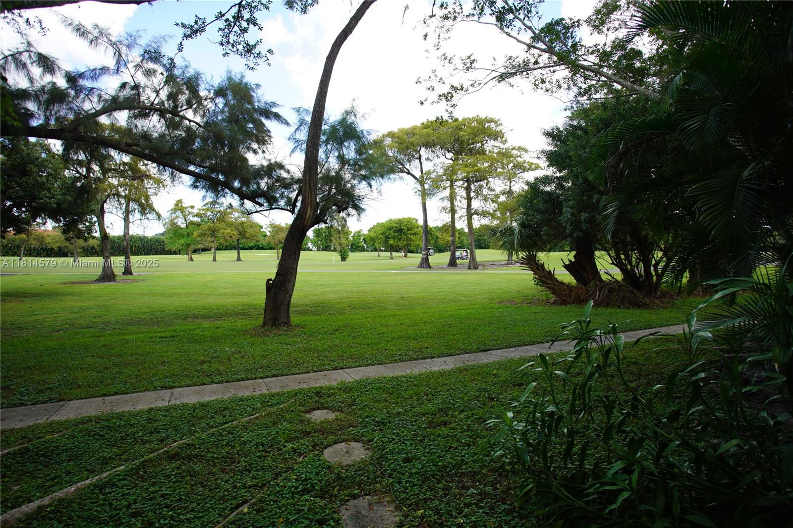 8380 Sands Point Boulevard, Unit J110 Tamarac, FL 33321 - Photo 33 of 34 a view of grassy field with benches and trees all around